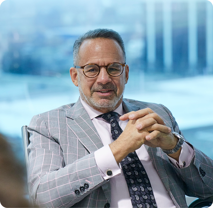 Stephen Durbin, family lawyer in Canada, seated in office wearing suit and glasses, professional portrait.