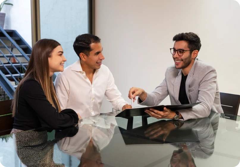 Family law lawyer consulting a couple about enforcing court orders during a legal meeting.
