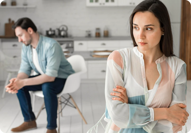 Couple sitting separately, indicating breakdown of communication in a relationship.