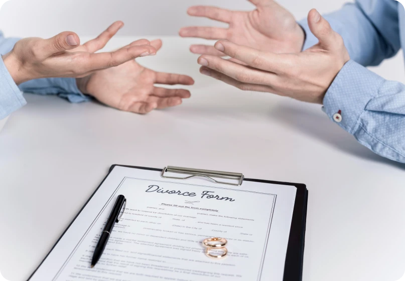 Couple reviewing a divorce form while discussing marital fraud with a lawyer.