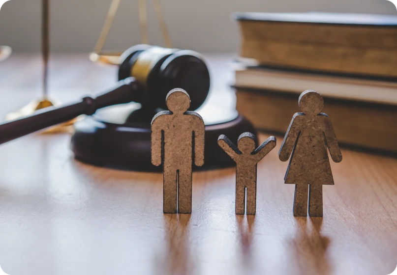 Judge’s gavel beside two wedding rings symbolizing marital fraud and legal action.