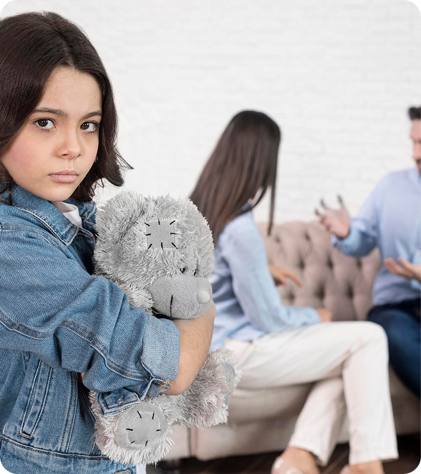 Emotional child witnessing parents arguing during family conflict.