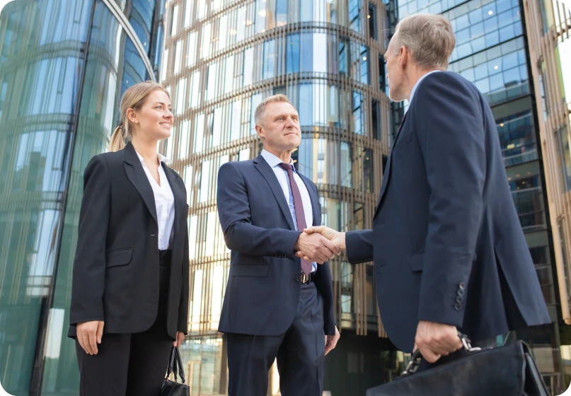 Legal professionals shaking hands after resolving a joint venture dispute in family law