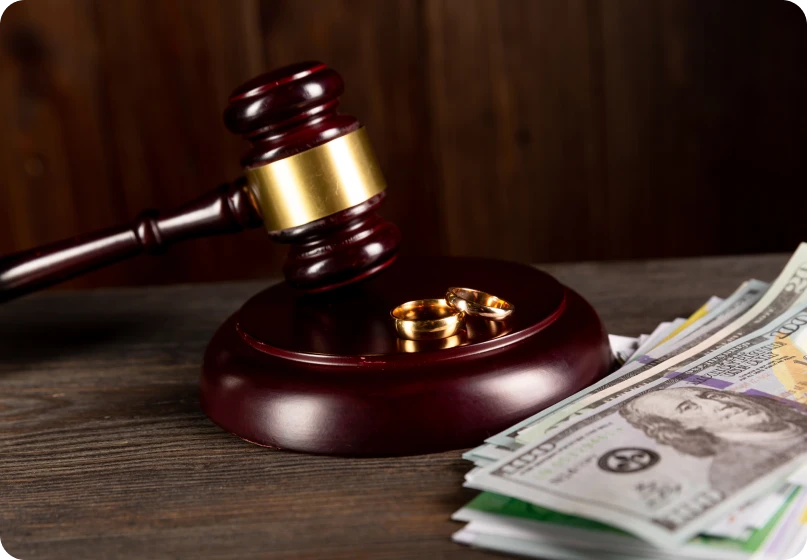 Courtroom gavel with wedding rings representing legal issues in marriage and fraud claims.