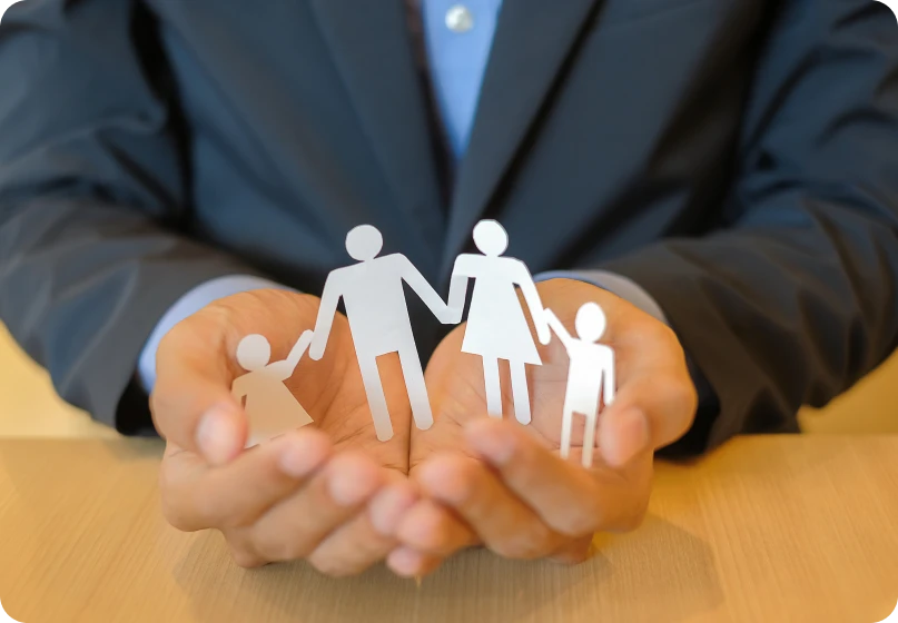 Lawyer holding paper cutout family representing collaborative family law and child custody planning.